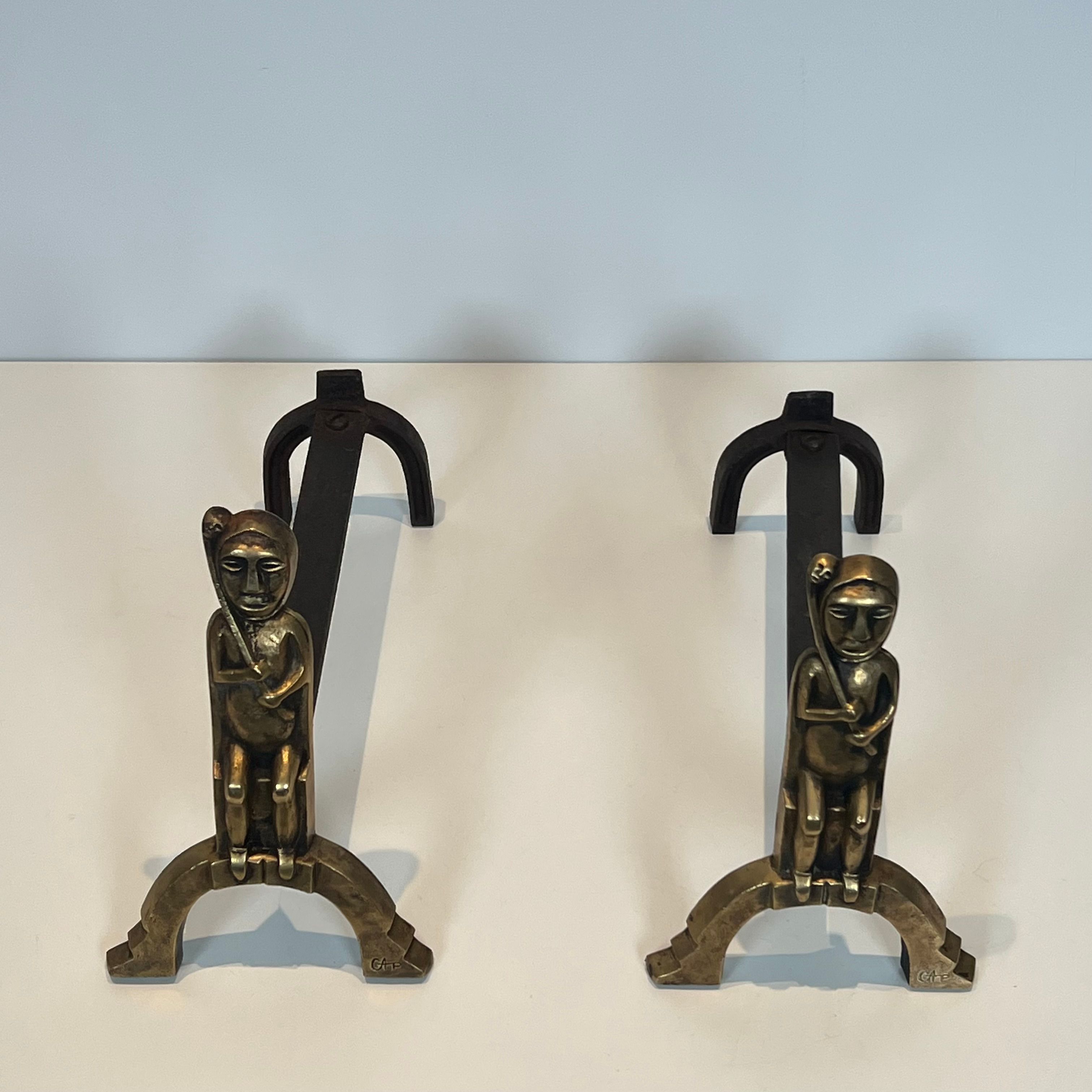 Pair of bronze andirons with seated shamans monogrammed Anton Prinner