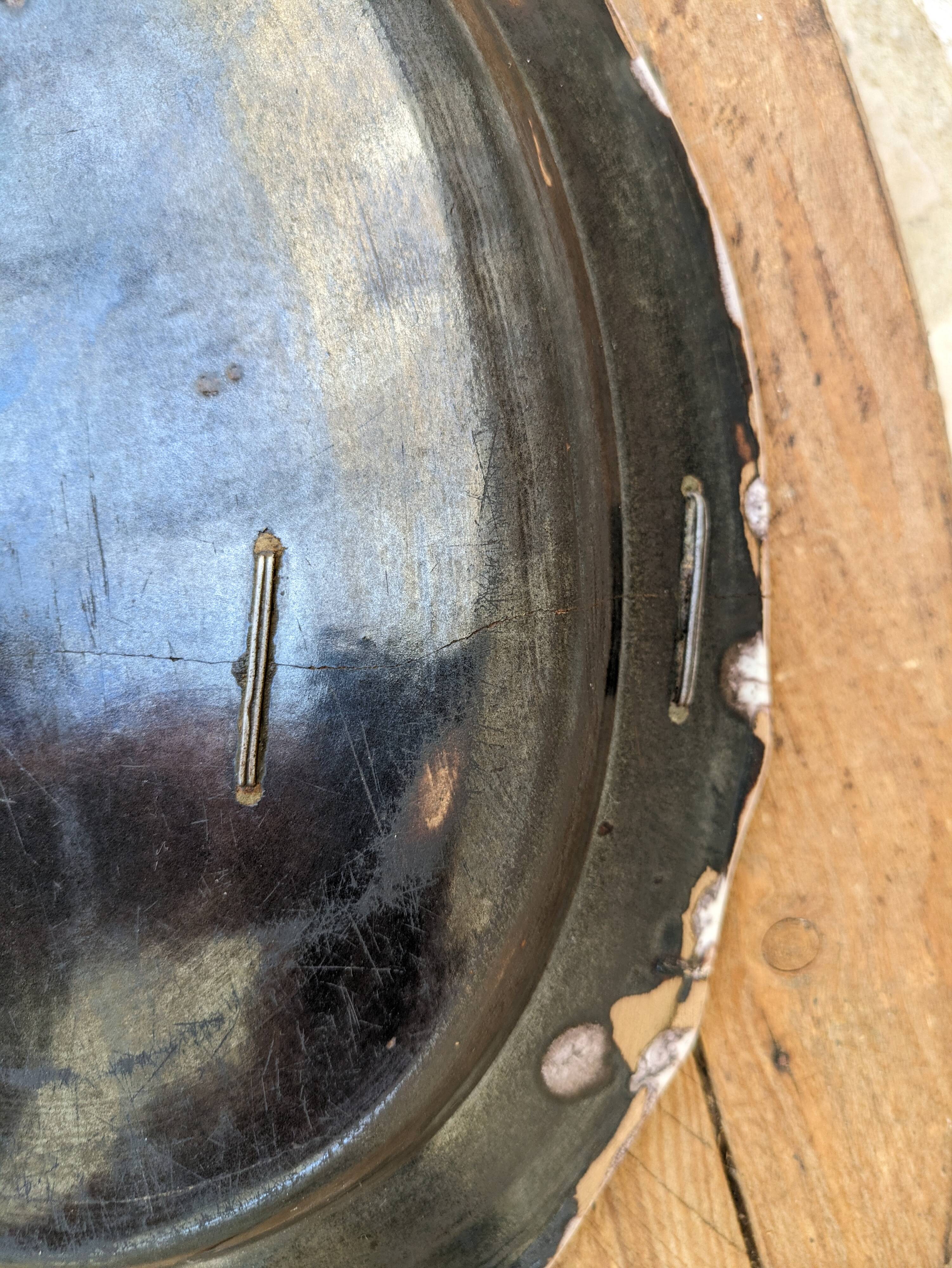 Old oval dish with floral motif called black bottom with staples