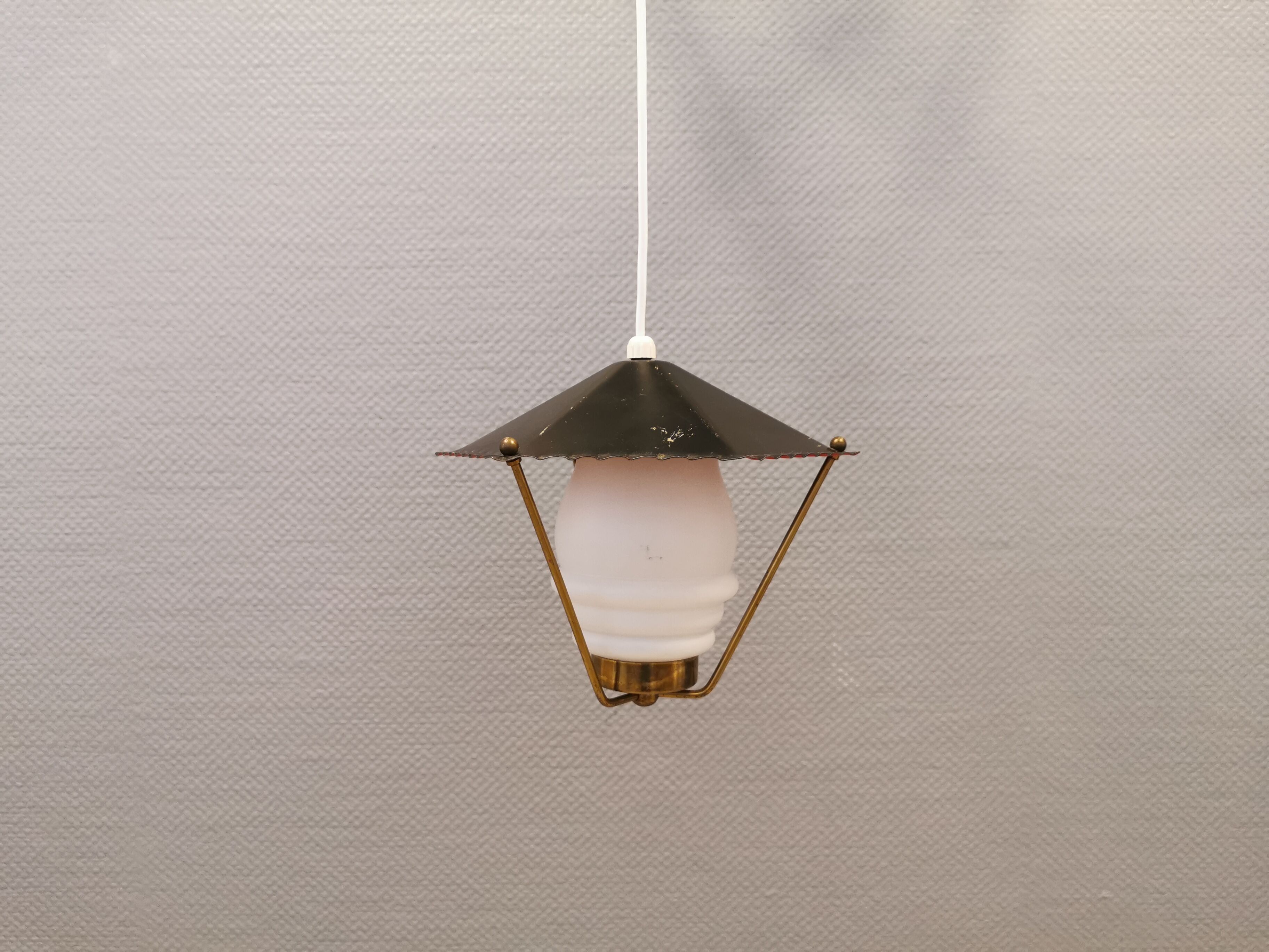 Danish hanging lamp from the 50-60s, made of brass, metal and with milky white glass shade.