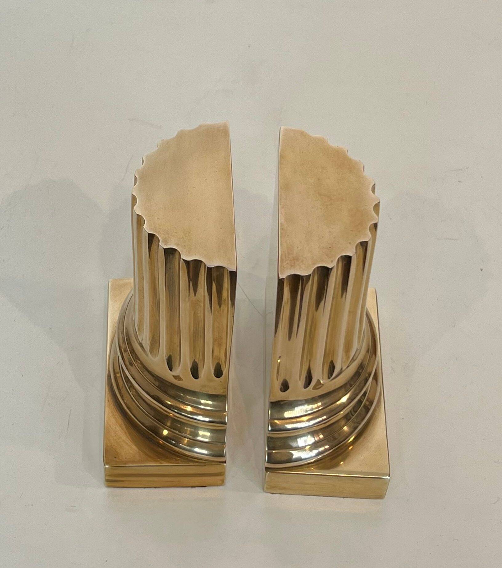 A pair of brass bookends representing columns.