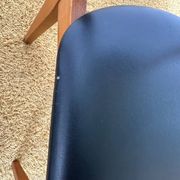 4 Scandinavian chairs in teak and black faux leather.