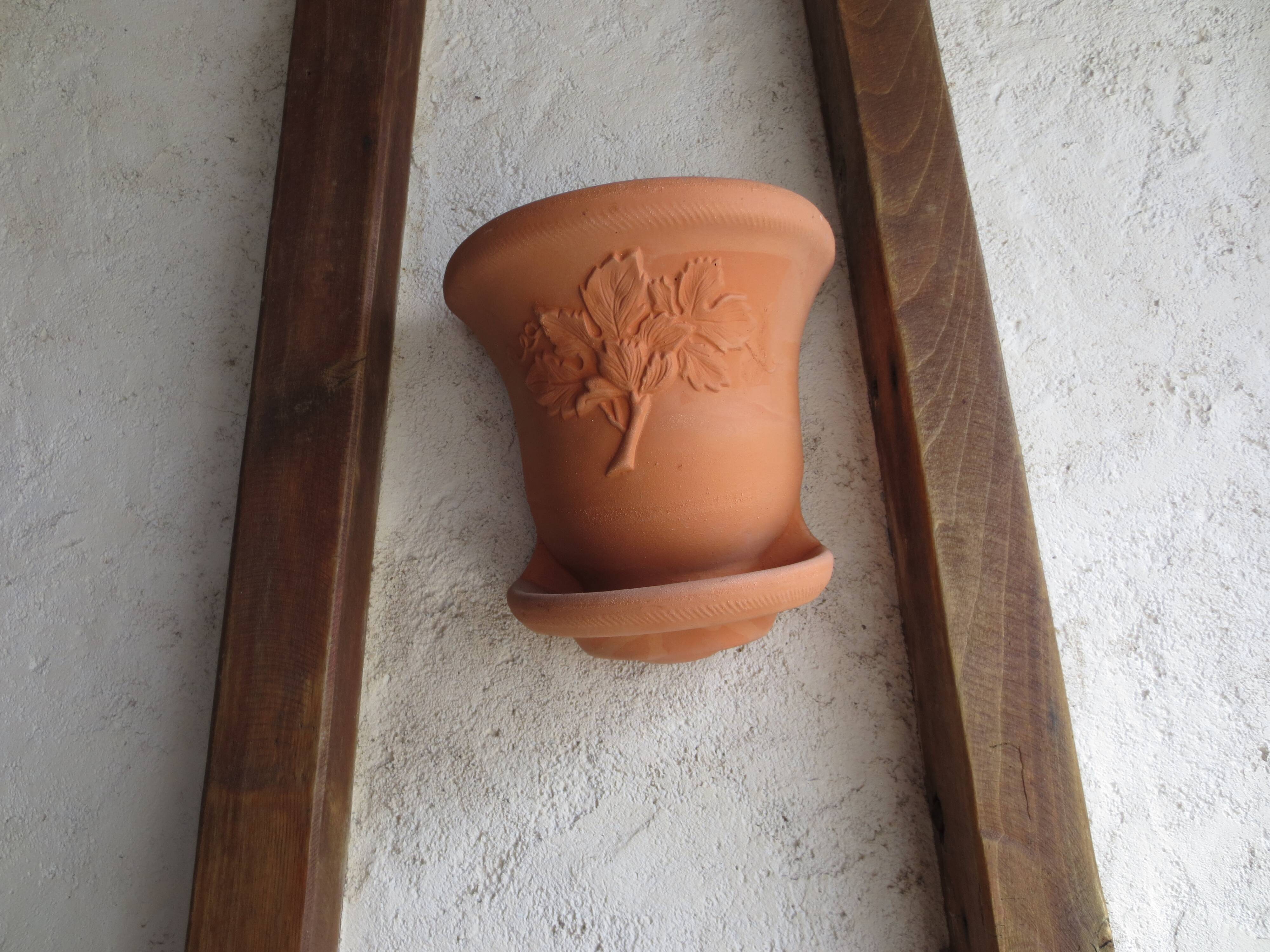 Pair of decorated terracotta wall flower pots