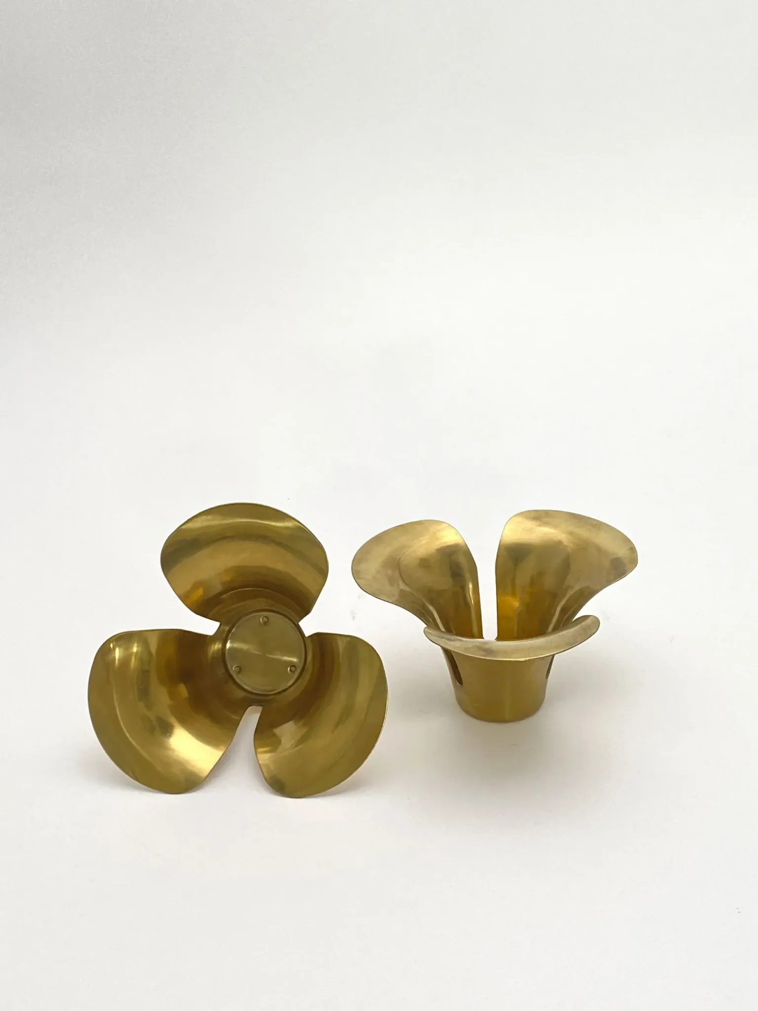 Brass candle holders in the shape of a flower.