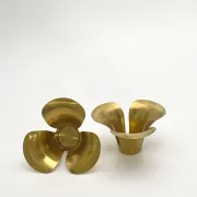Brass candle holders in the shape of a flower.