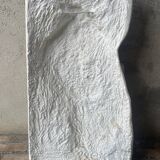 Ancient plaster bas-relief of Nike fastening her sandal.