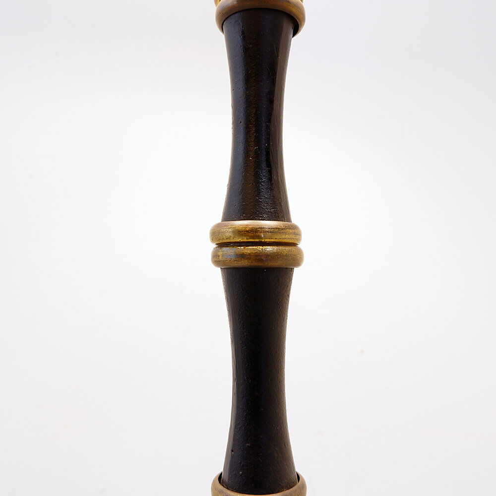 Tripod floor lamp in wrought iron and brass with bamboo-style base.