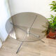 Round tripod table in smoked glass Roche Bobois 70