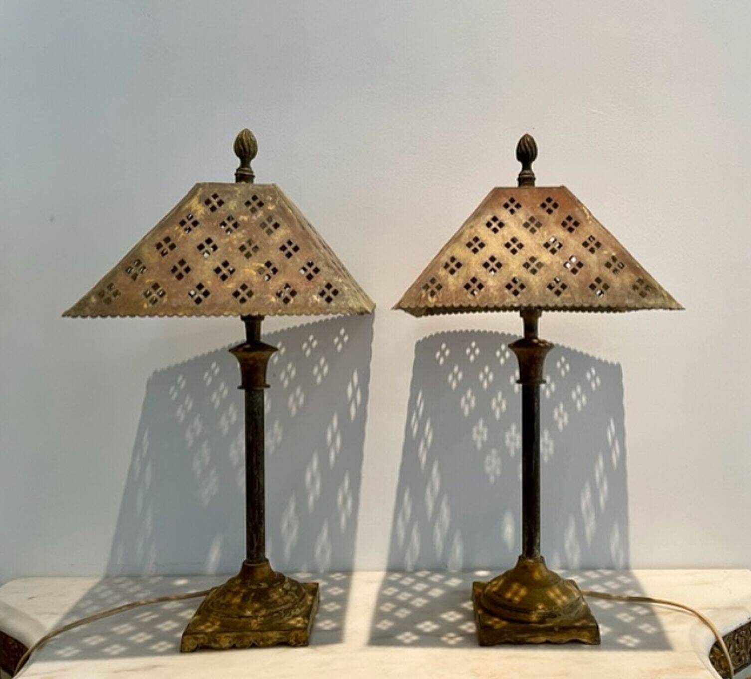 Pair of lamps in patinated gold metal