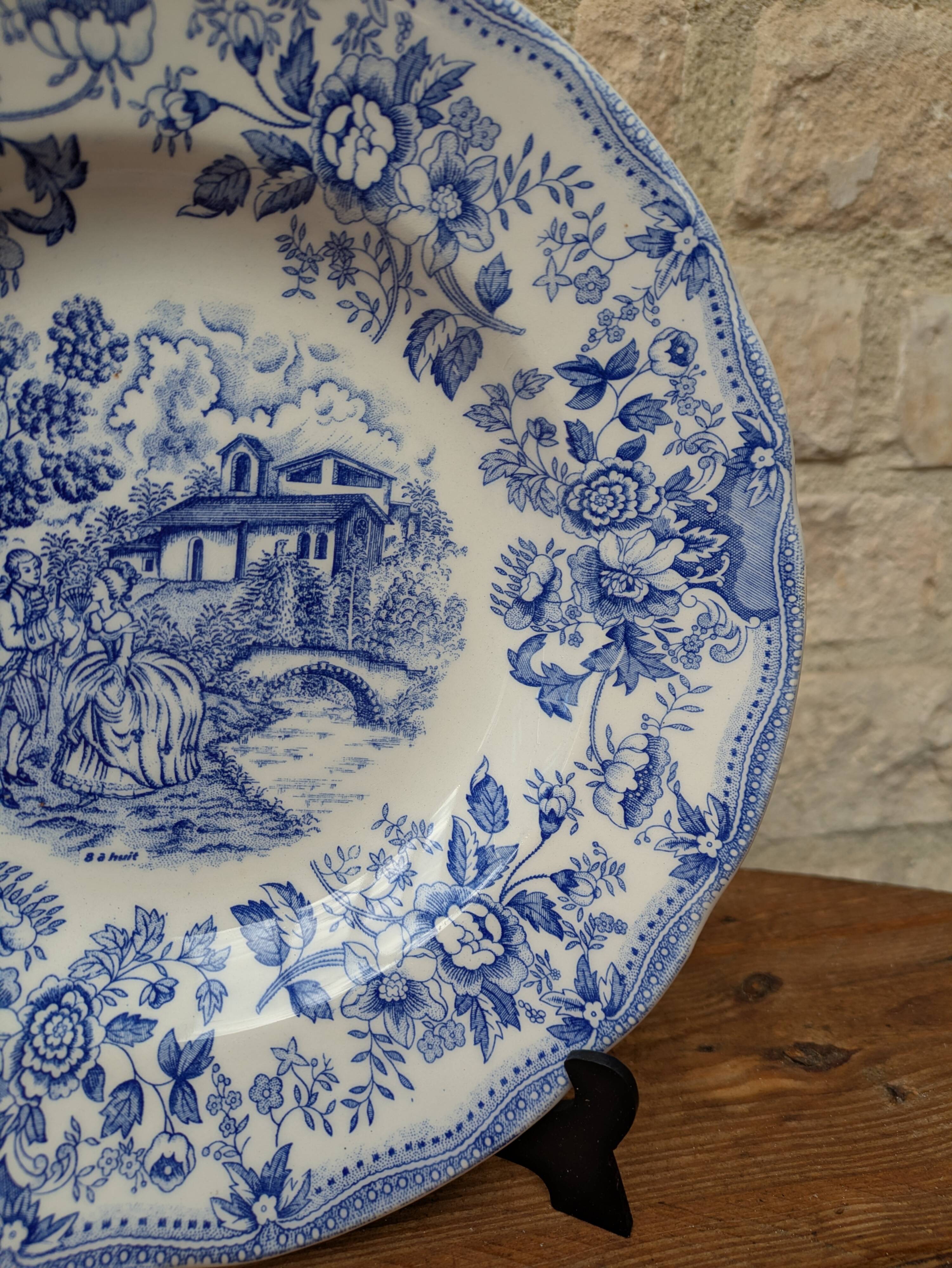 Old deep plate with blue floral pattern and gallant scene