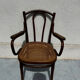 Thonet armchair stamped with curved wooden armrests and caning from the 19th century.