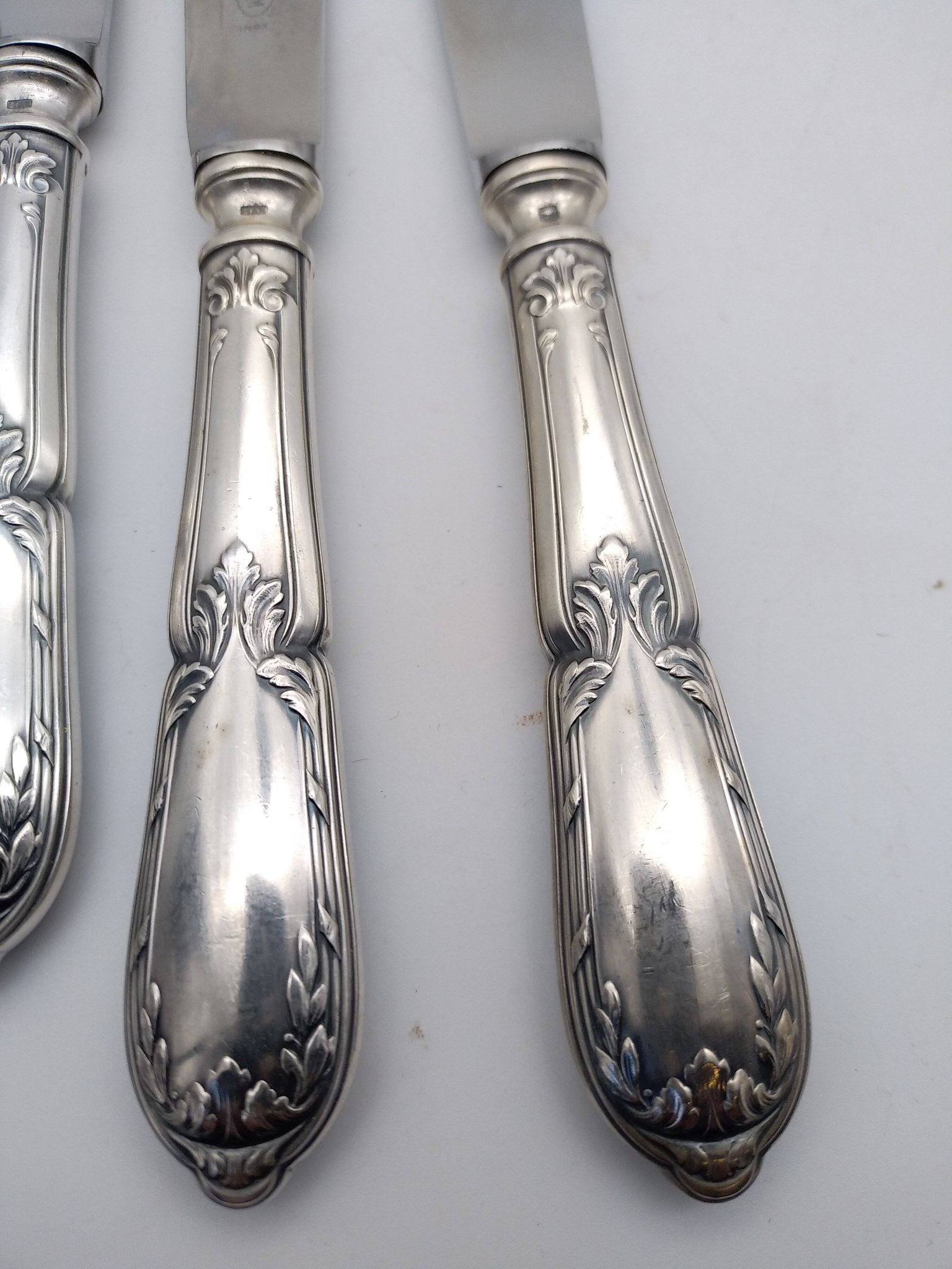 Set of 12 sfam knives in silver metal and stainless steel blades.