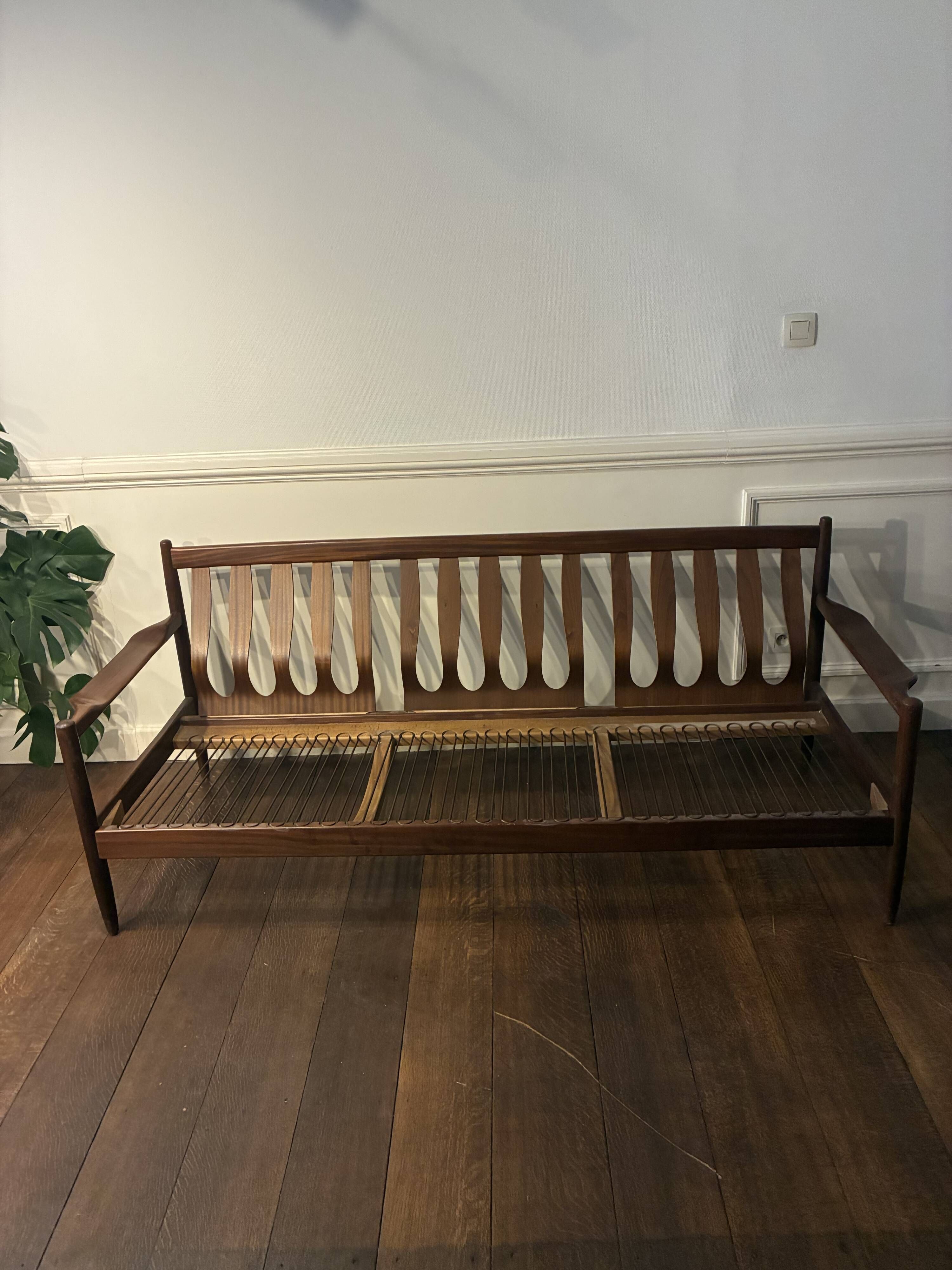 Vintage three-seater sofa — wood and sculptural backrest