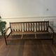 Vintage three-seater sofa — wood and sculptural backrest