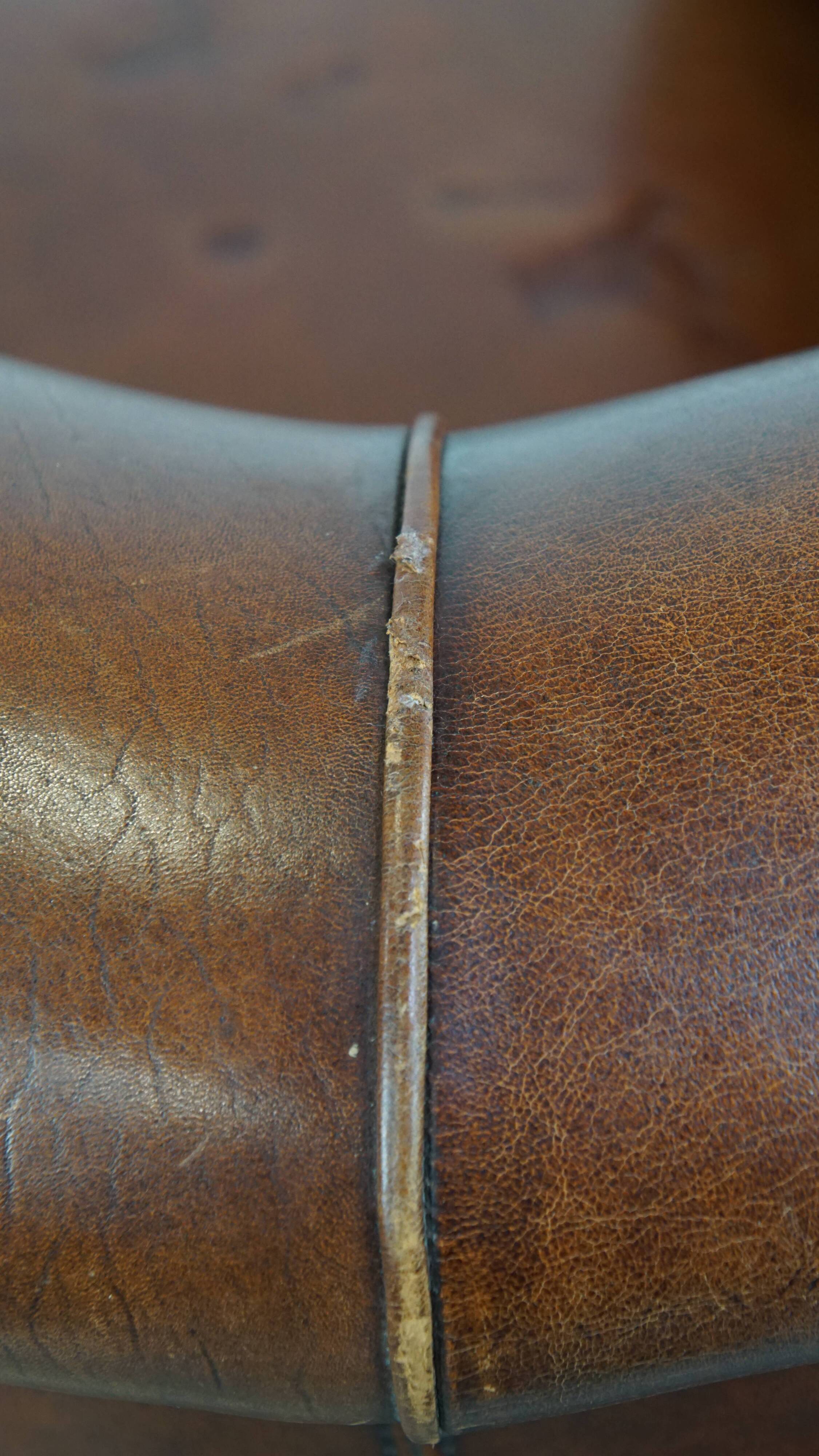 Sheep leather club chair in a cognac color and finished with piping