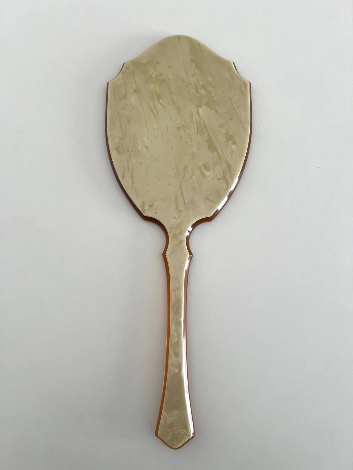 Chic coral orange hand mirror with a mother-of-pearl back – elegant retro style.