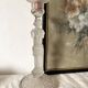 Tall molded glass candle holder with ram heads