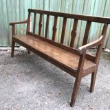 Duo of old solid oak benches with backs and armrests.