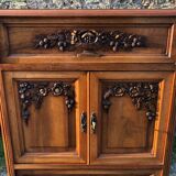 Art Deco sideboard bar cabinet in solid walnut with 3 doors and 1 richly carved tilting false drawer.