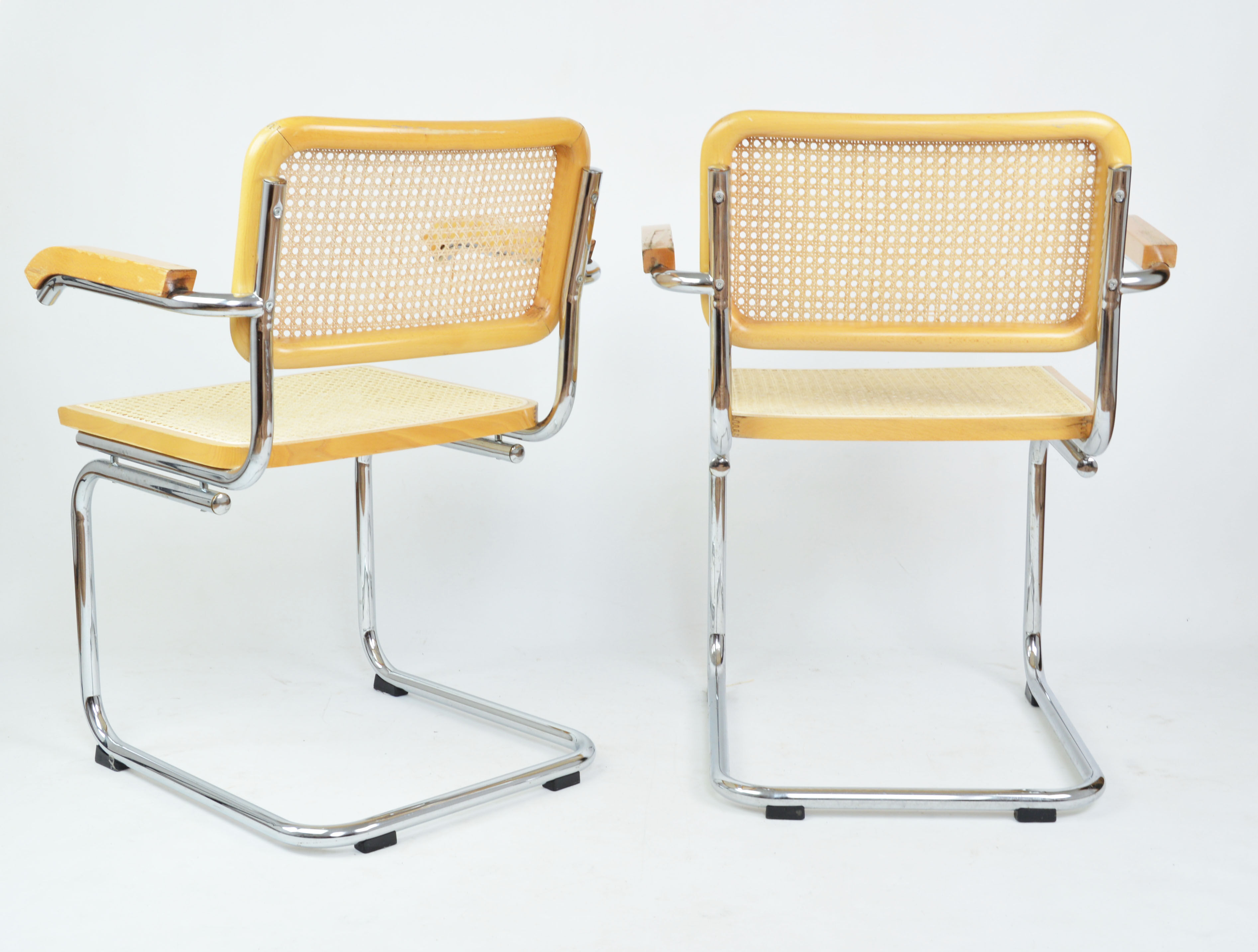 A pair of chairs with armrests, 1970s
