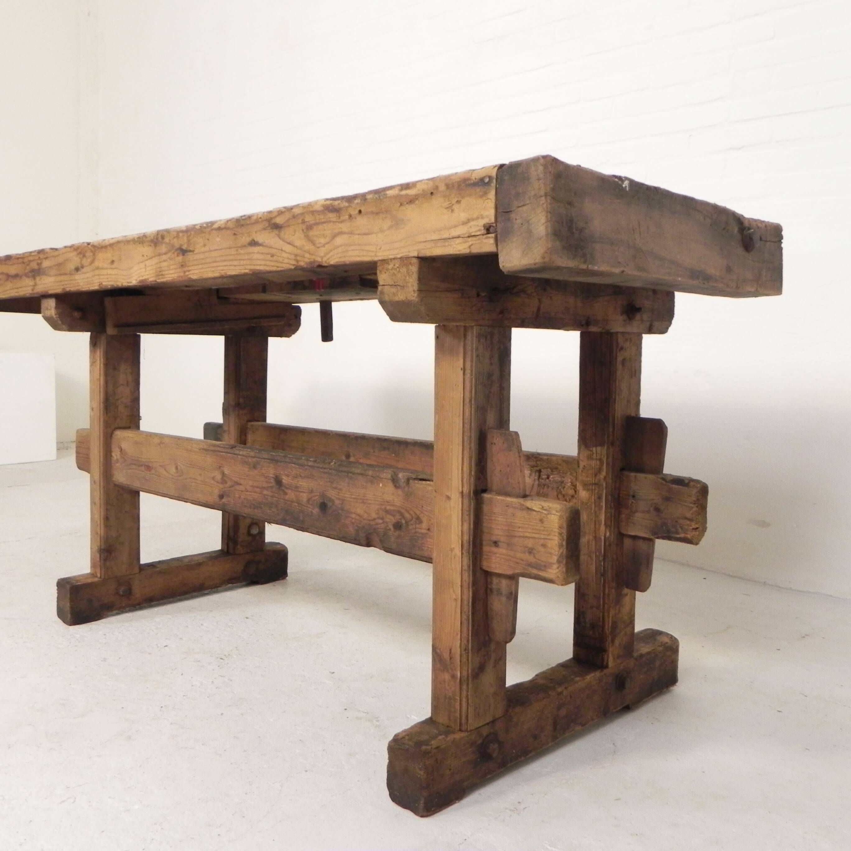 Wooden industrial workbench with vice, 194 cm long, 1930s.
