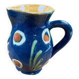 Small blue ceramic jug with hand-painted floral decoration, vintage.