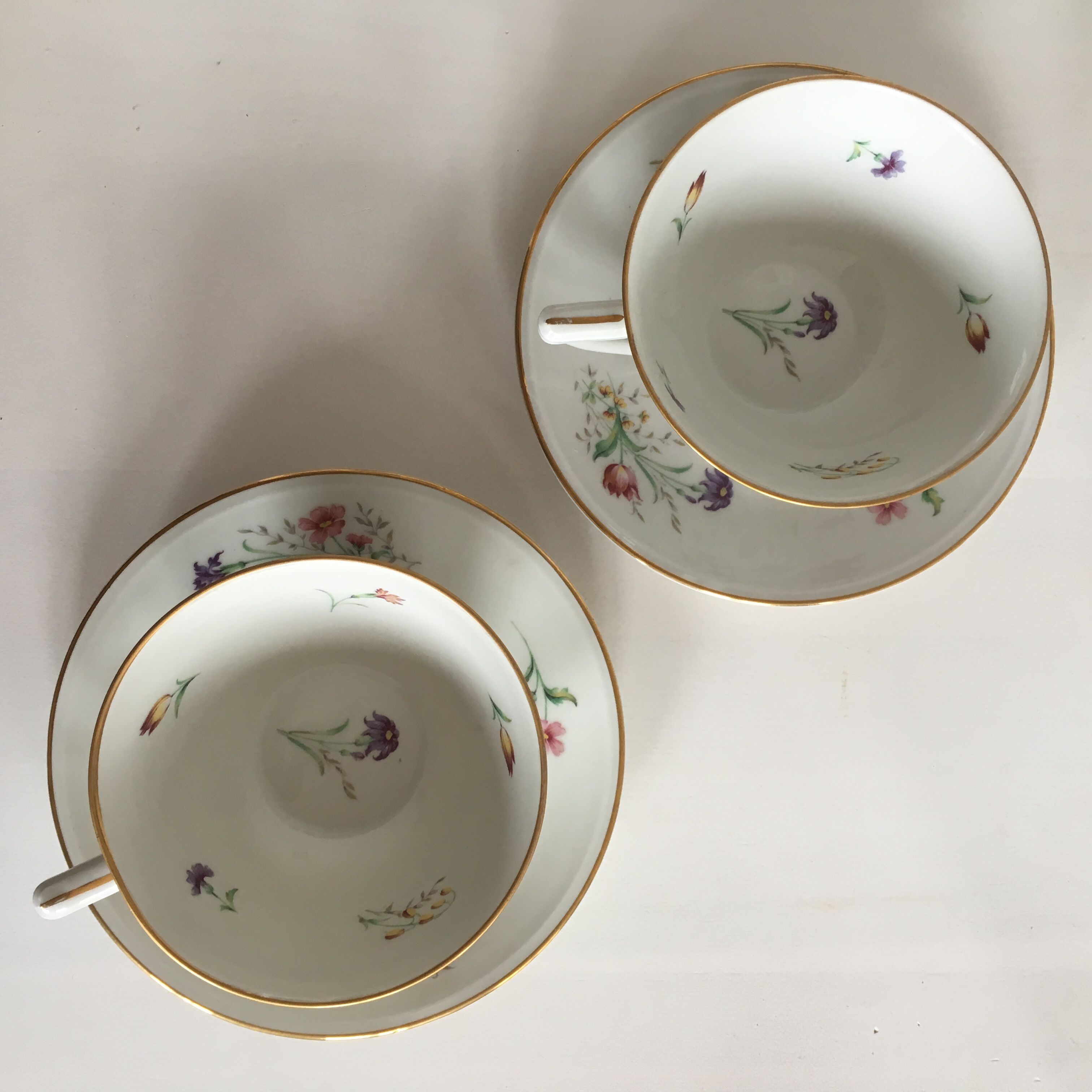 Duo of white Limoges porcelain cups with flowers