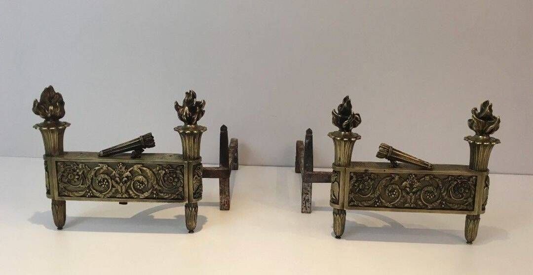 Pair of Empire Period Chenets in Chiselled Bronze with Torches and Leaf Frieze
