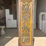 Rectangular Indonesian construction element with blue and yellow plant in carved wood