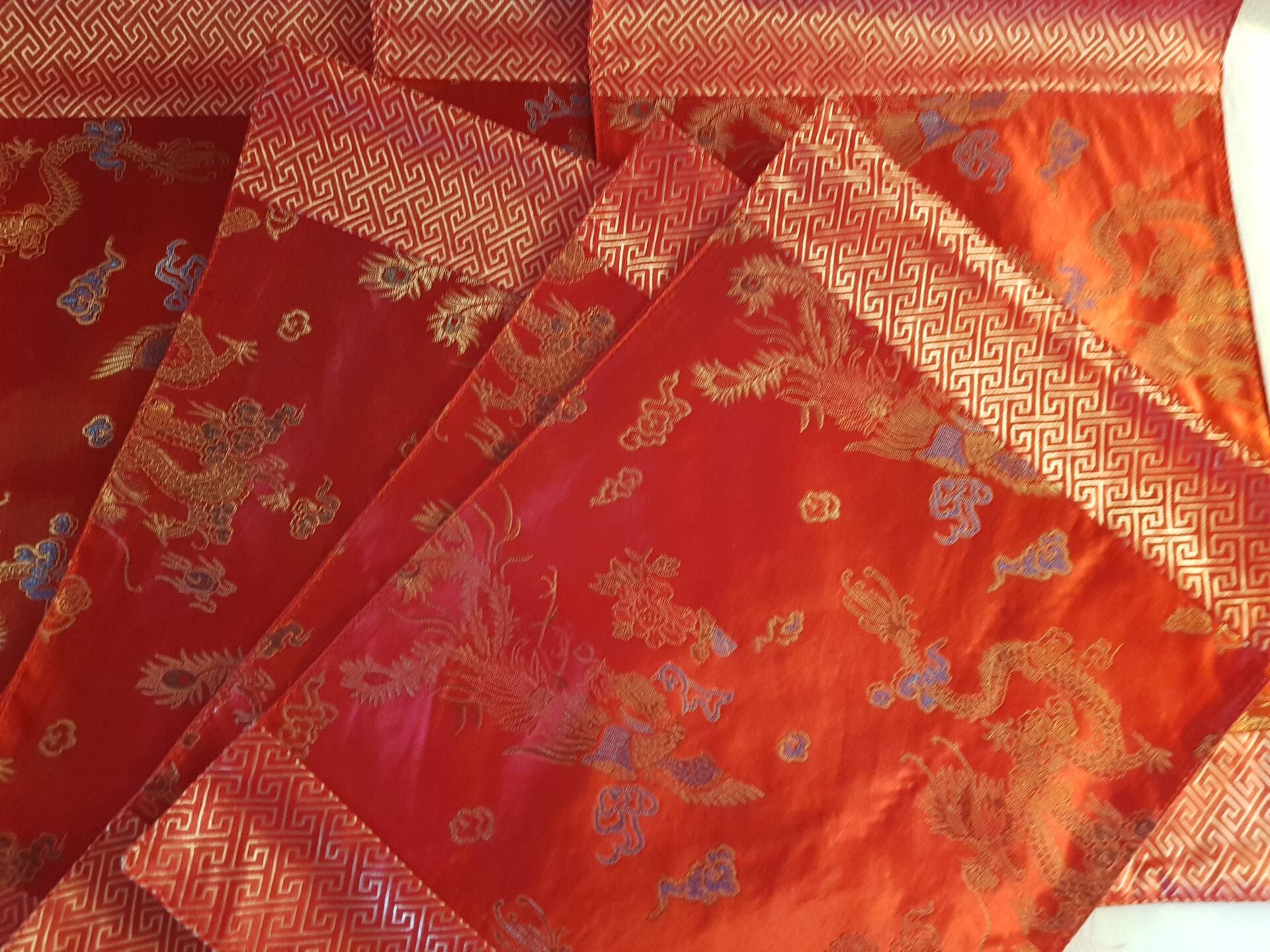 Set of 6 small table napkins in red brocade.