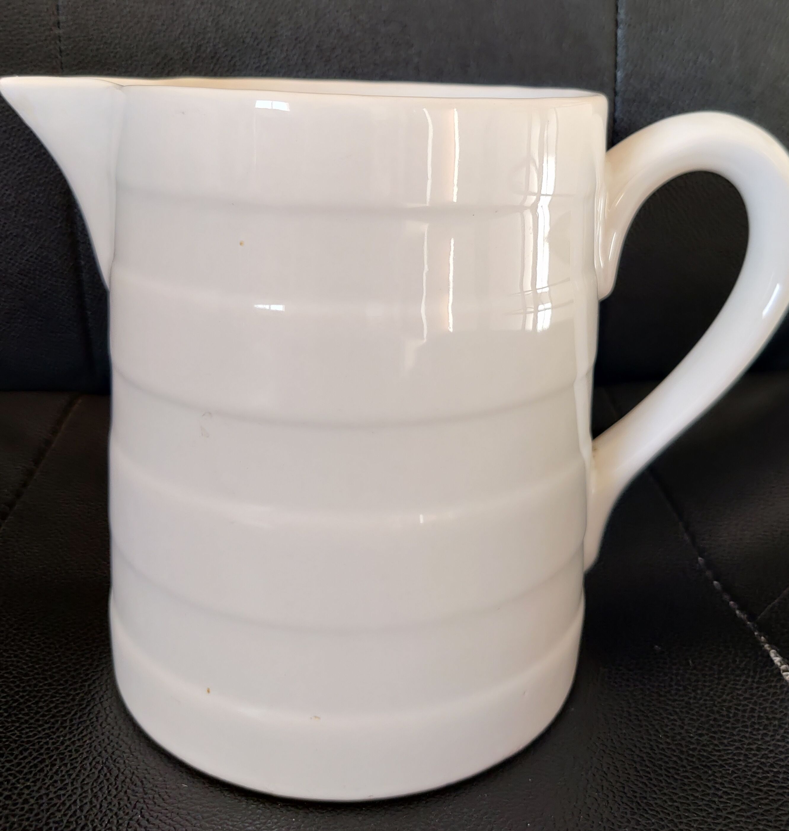 Antique white ceramic pitcher