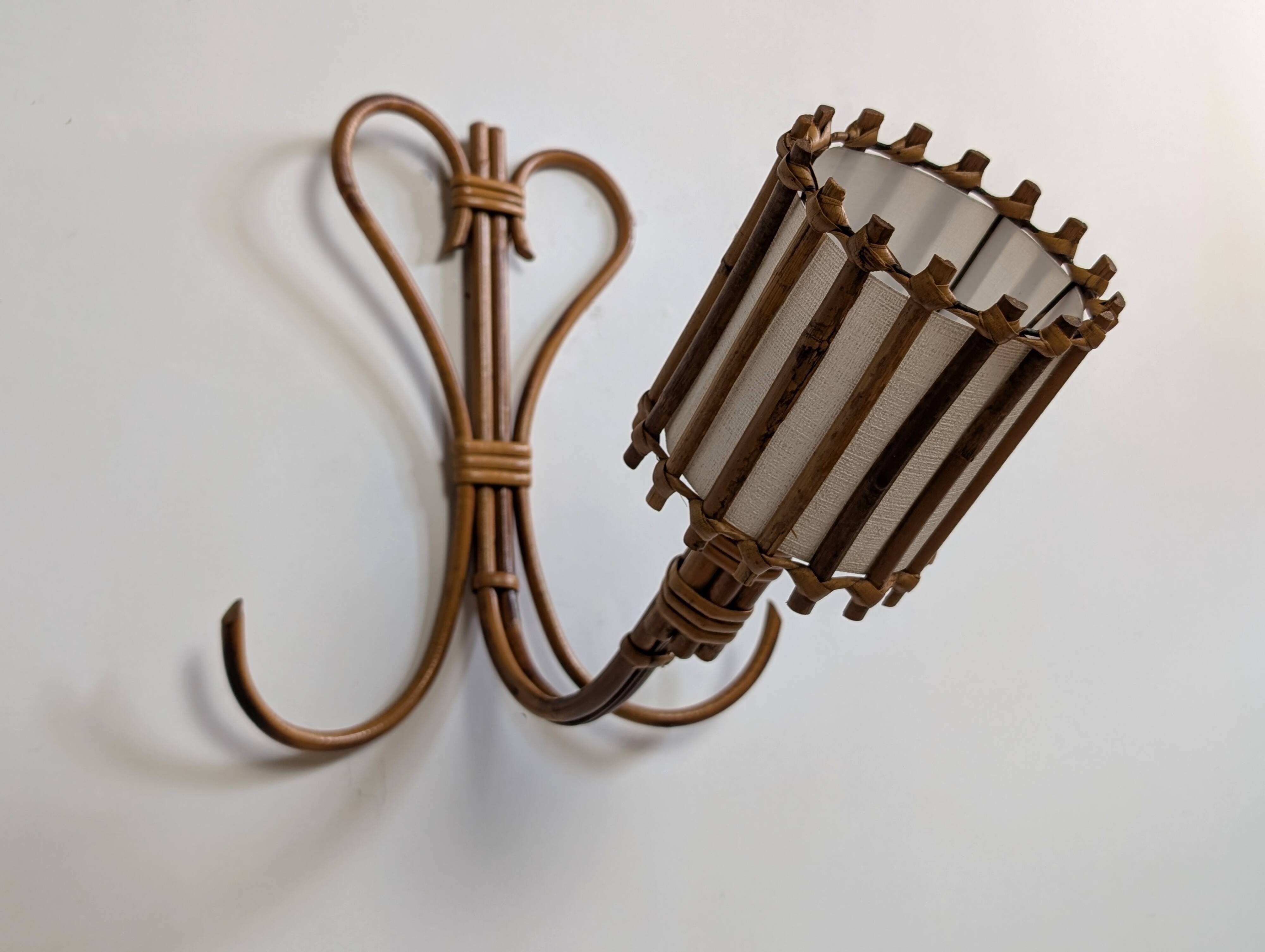 Rattan wall lights by Louis Sognot