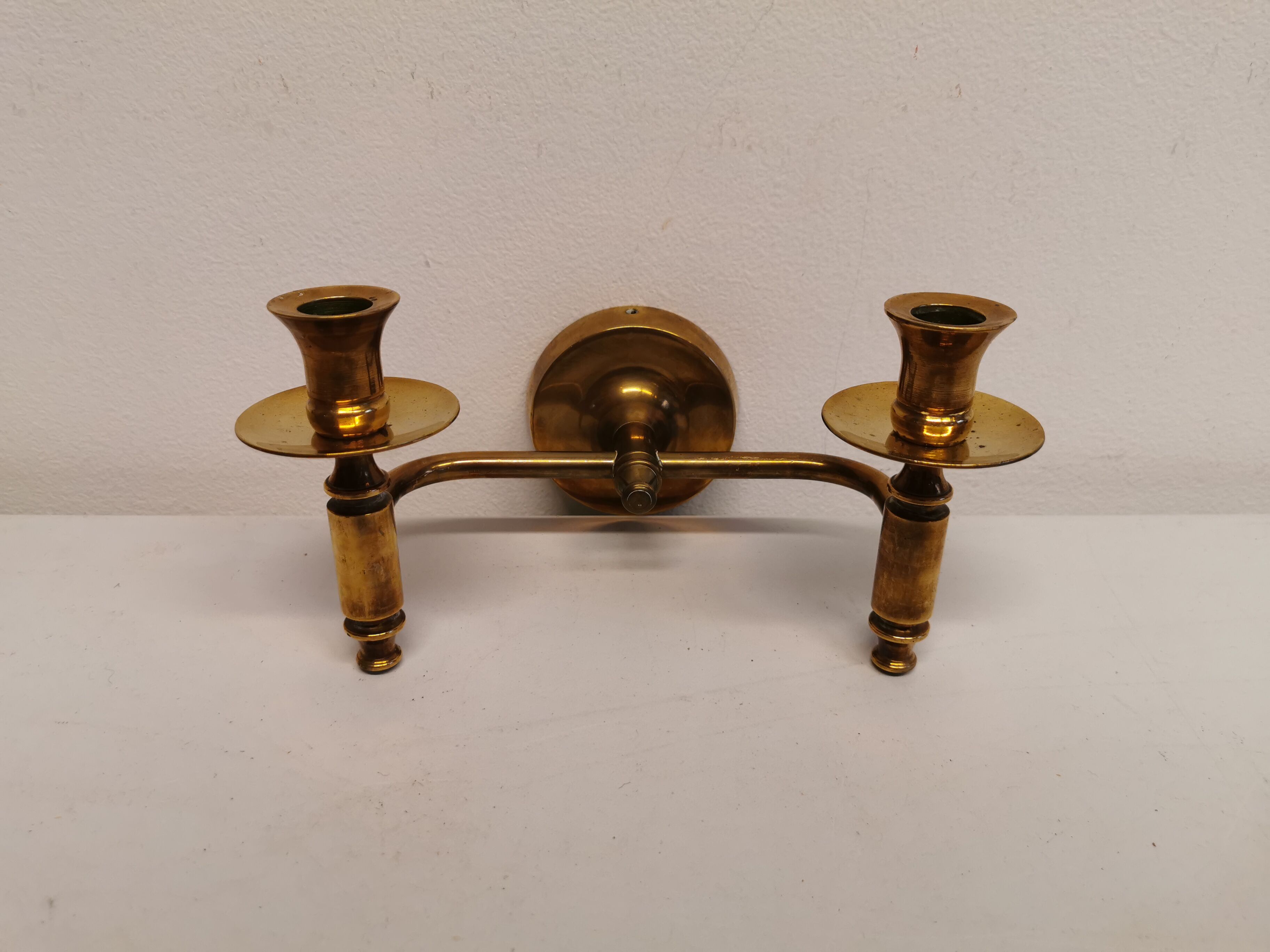 Classic Danish wall hung design candlestick in solid brass