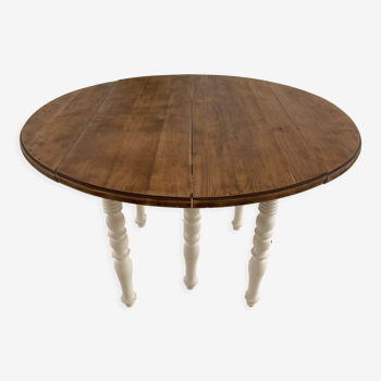 Extendable round table in raw and white wood