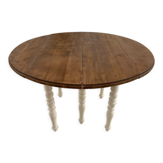 Extendable round table in raw and white wood