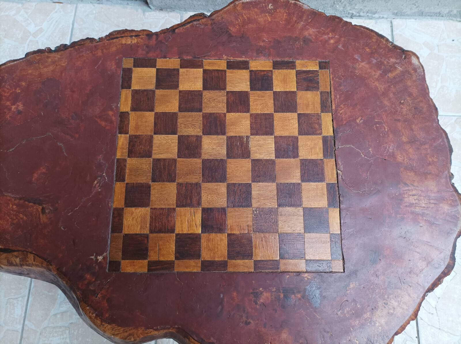 Brutalist chessboard coffee table made from tree stump.