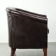 Dark cow leather club armchair with a stylish design in English style