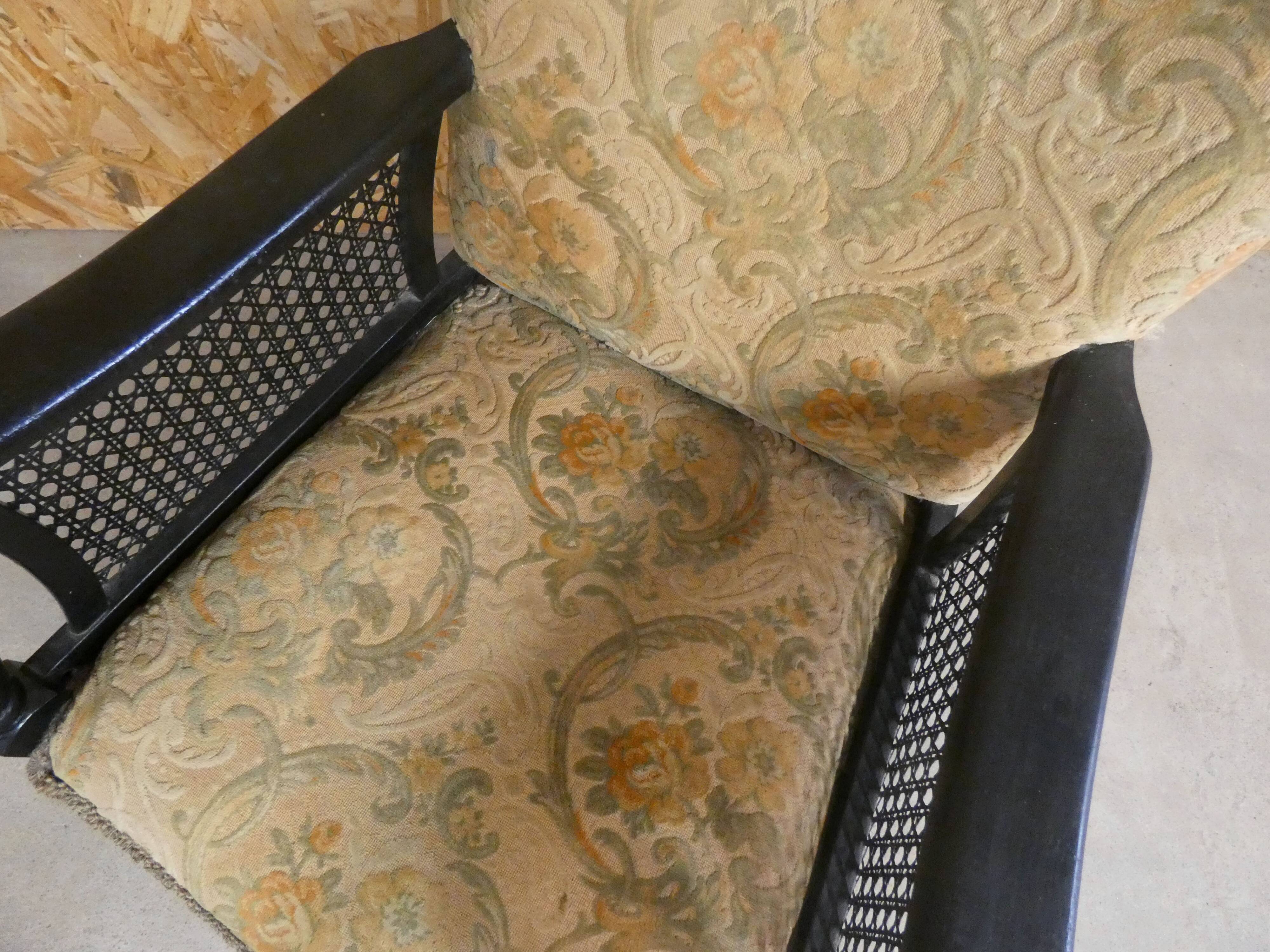 Old armchair upholstered in velvet, carved and caned wood