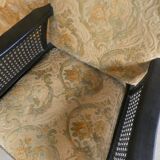 Old armchair upholstered in velvet, carved and caned wood