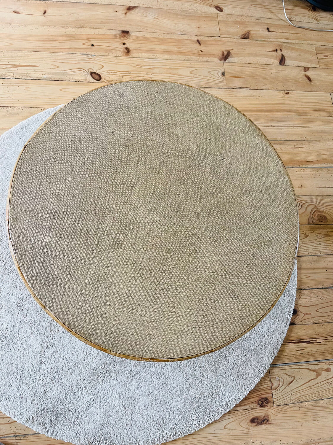 Tripod coffee table with a straw covering.