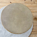 Tripod coffee table with a straw covering.