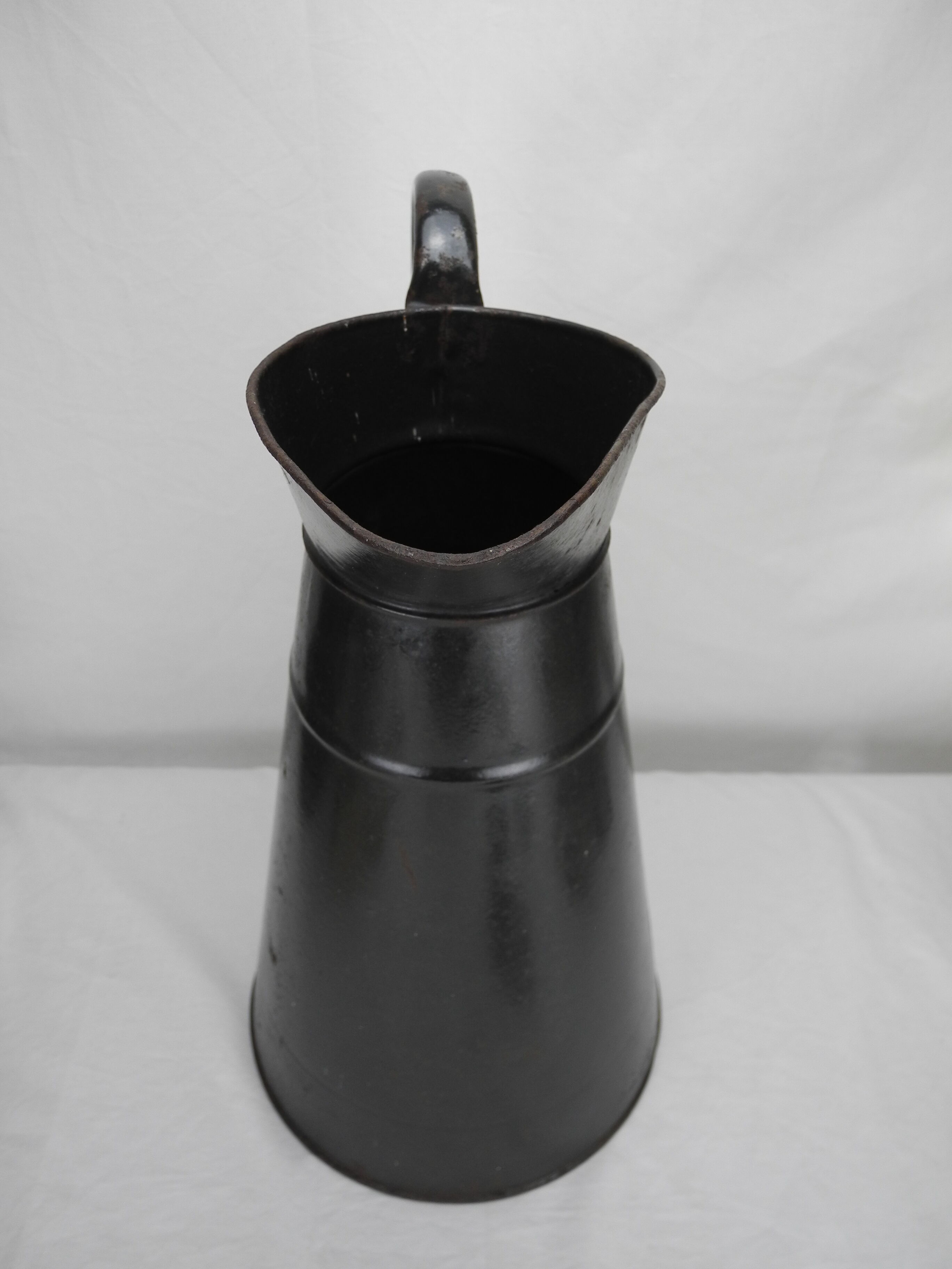 Old enamelled sheet metal jug