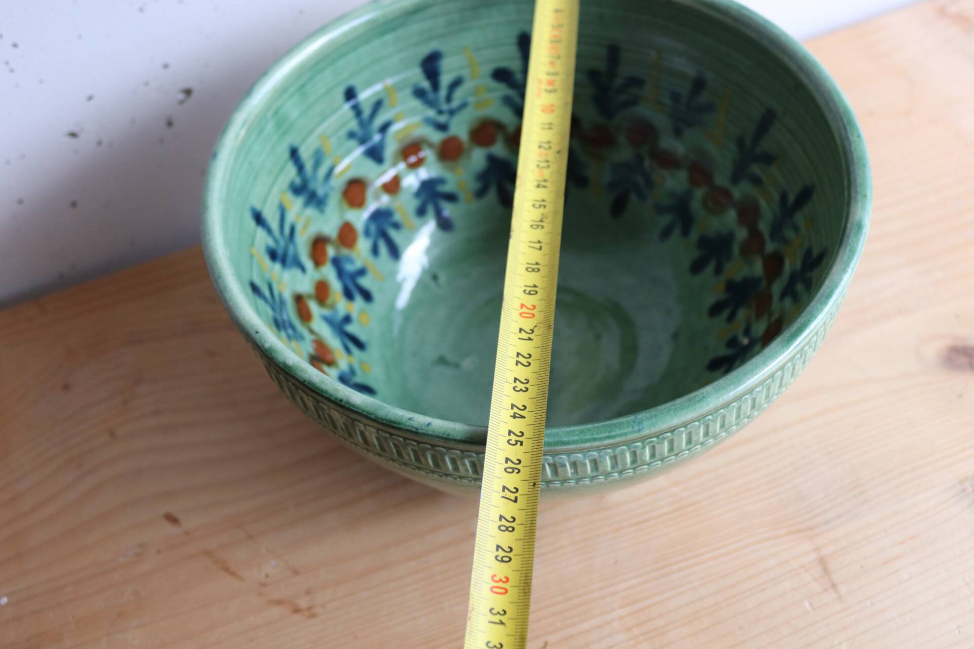 Large glazed ceramic salad bowl with a floral design.