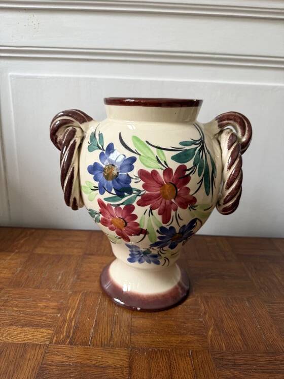 Ceramic vase with hand-painted floral decoration.