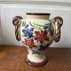 Ceramic vase with hand-painted floral decoration.