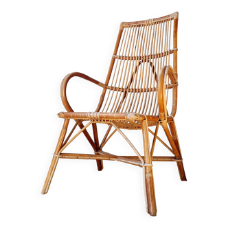 Antique rattan armchair with a high back.