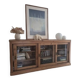 Antique wooden sideboard with three sliding glass doors.