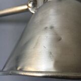 Old industrial lamp has vise 'mazda '.