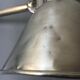 Old industrial lamp has vise 'mazda '.