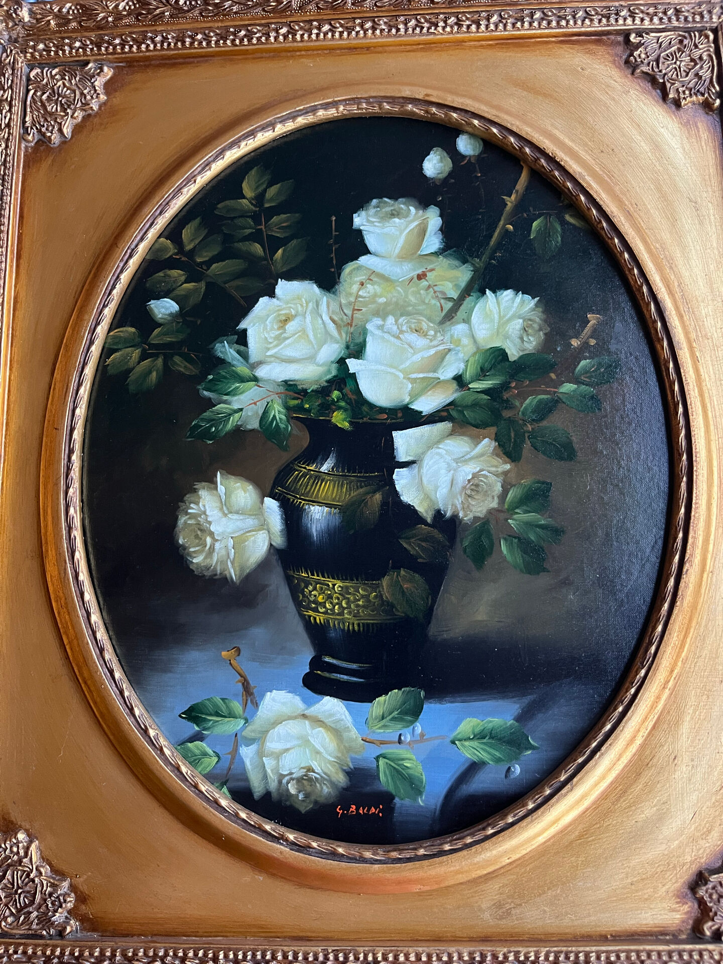 Large still life with white roses in an old gilded oval frame.