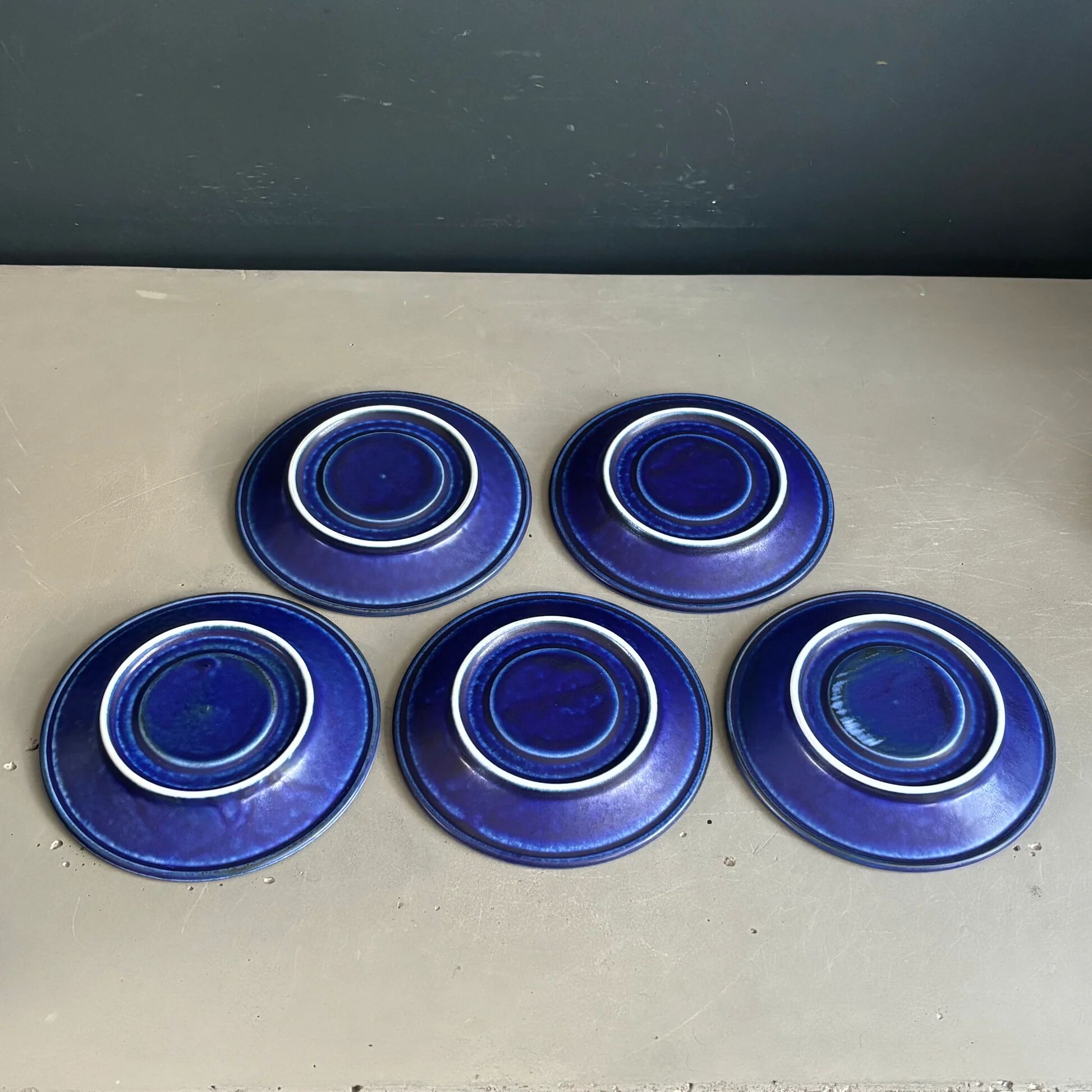 Set of 5 blue Klein ceramic tea cups with saucers.